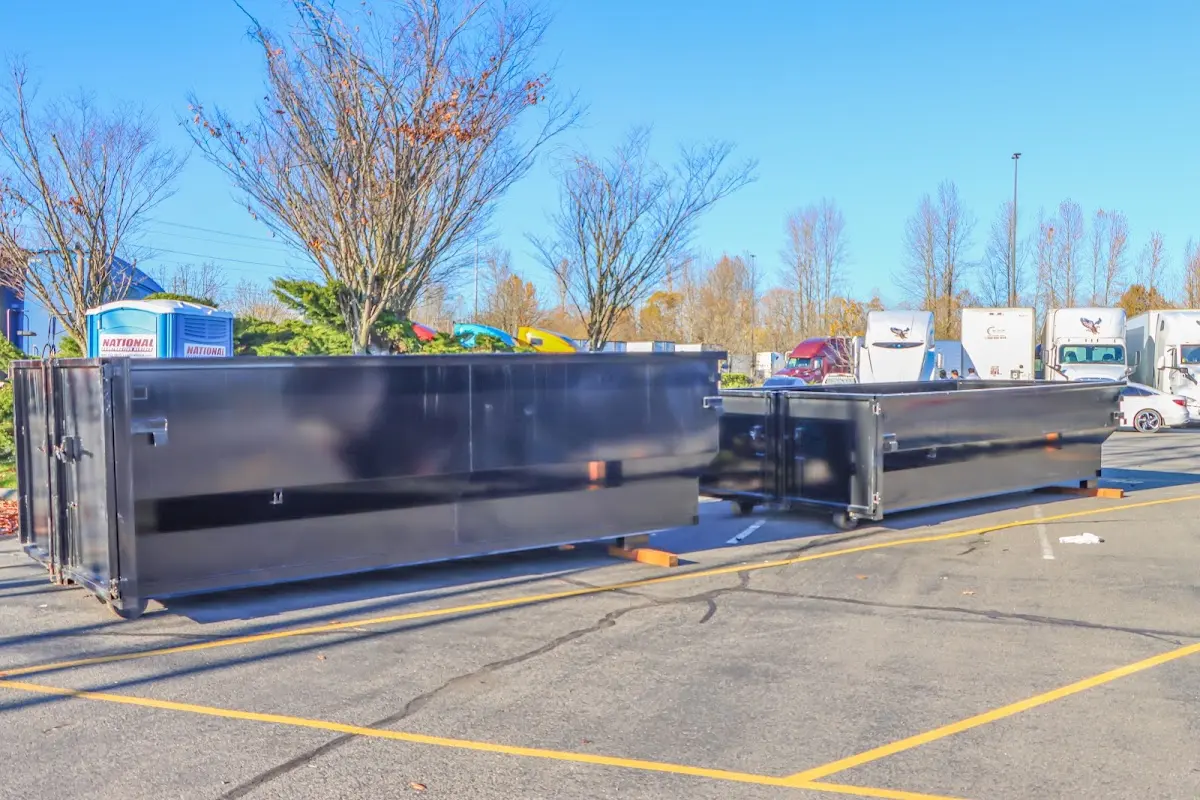 Professional dumpster rental service with roll-off container on residential driveway in West Linn